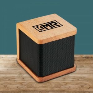 Custom wireless speaker that is made out of mahogany wood on top of the desk